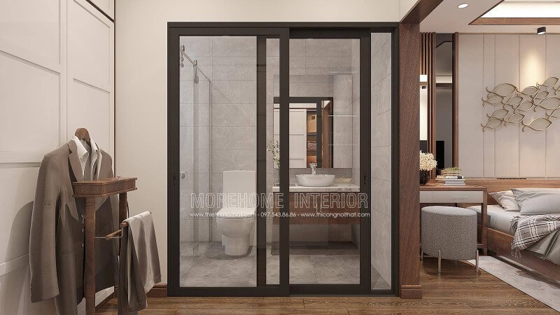 Bố trí nội thất phòng ngủ khép kín với xu hướng mở khi sử dụng tấm ốp tường gỗ óc chó như tạo ranh giới phân chia cùng thiết kế cửa kính trượt.